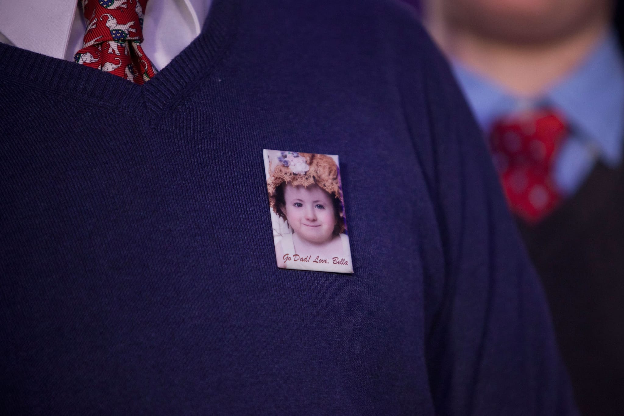 A supporter of Republican presidential hopeful and former U.S. Sen. Rick Santorum wears a pin with a photo of Bella Santorum, Rick's daughter, which reads "Go Dad! Love, Bella" while Rick gives his speech at the Stoney Creek Inn on January 3, 2012 in Johnston, Iowa. (Photo by Andrew Burton/Getty Images)