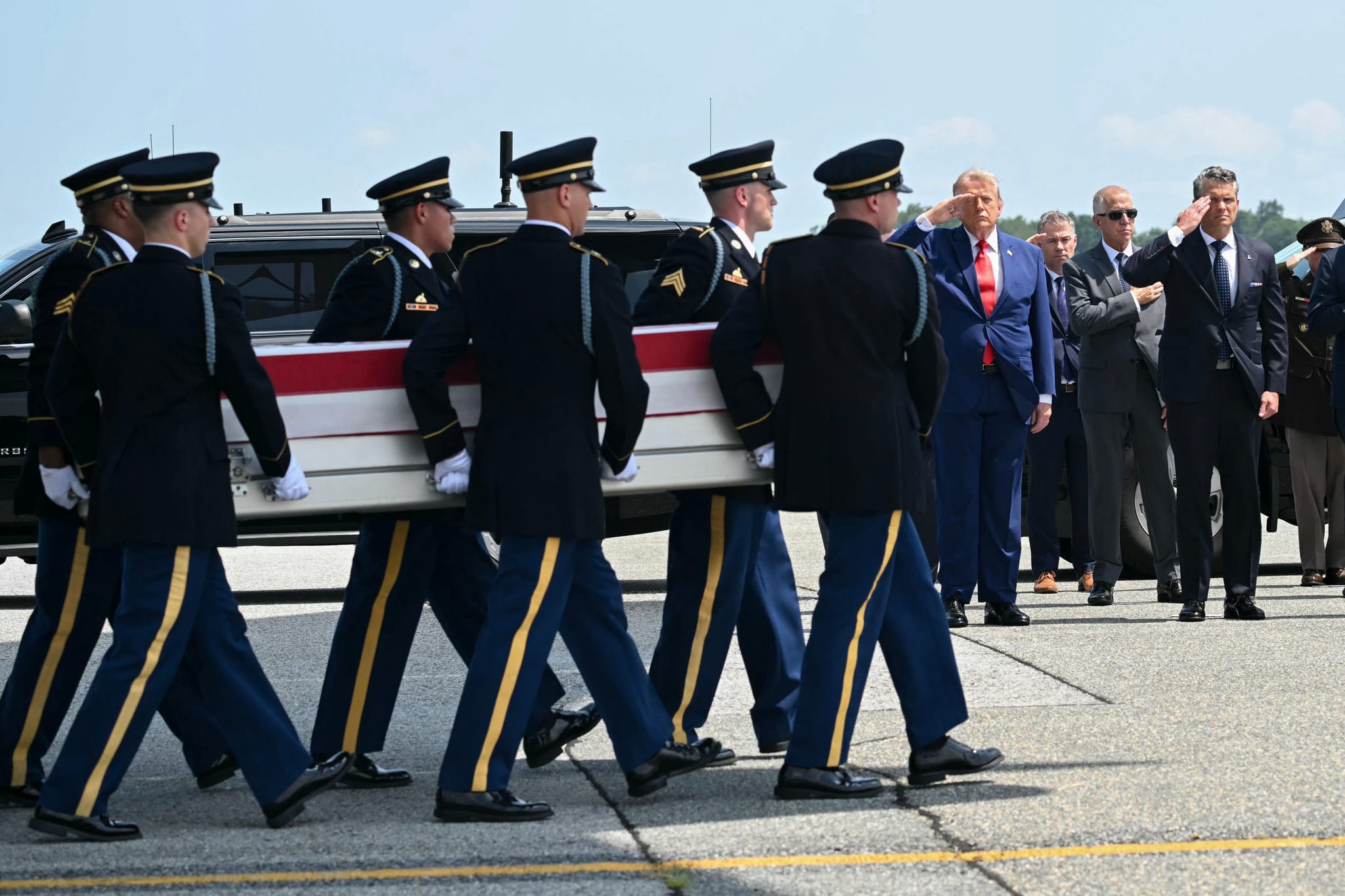 US President Donald Trump and Secretary of Defense Pete Hegseth salute as a US Army carry team carries the flag-draped transfer case containing the remains of Sgt. Angel S. Rampersad, 28, of Ozone Park, New York, during a dignified transfer solemn event for US service members killed during operations in the Middle East, at Dover Air Force Base in Dover, Delaware, on July 22.(Photo by SAUL LOEB / AFP via Getty Images)