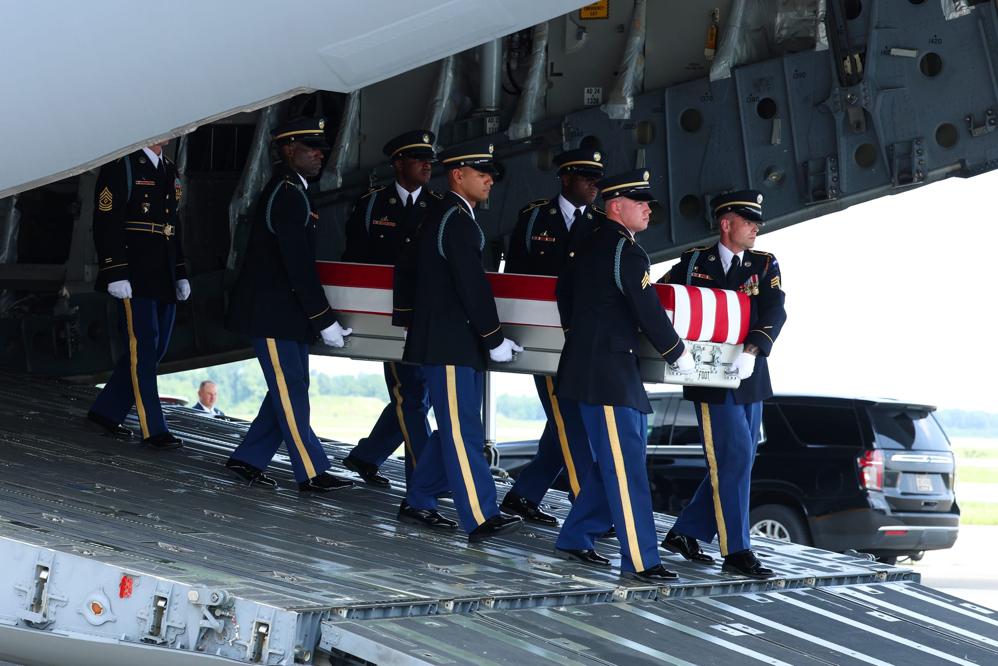 Members of a U.S. Army carry team move the flag-draped transfer case holding the remains of Army Pvt. Isabella Gonzales, of Carrollton, Texas, during a dignified transfer at Dover Air Force Base July 22, 2026 in Dover, Delaware. Pvt. Gonzales, who was assigned to 1st Battalion, 57th Air Defense Artillery Regiment, 52nd Air Defense Artillery Brigade, 10th Army Air Missile Defense Command in Ansbach, Germany, was killed in action during an enemy attack on July 17, 2026, at Muwaffaq Salti Air Base in Jordan. (Photo by Kevin Dietsch/Getty Images)