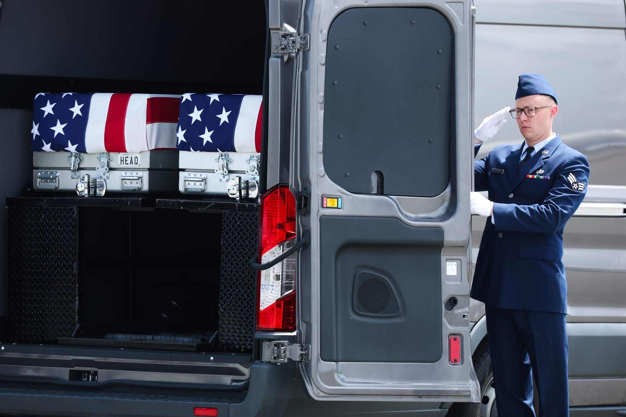Flag-draped transfer cases holding the remains of Army Pvt. Isabella Gonzales, of Carrollton, Texas, and Army Sgt. Angel S. Rampersad of Ozone Park, New York, are placed in a transfer van during a dignified transfer at Dover Air Force Base July 22, 2026 in Dover, Delaware. (Photo by Kevin Dietsch/Getty Images)